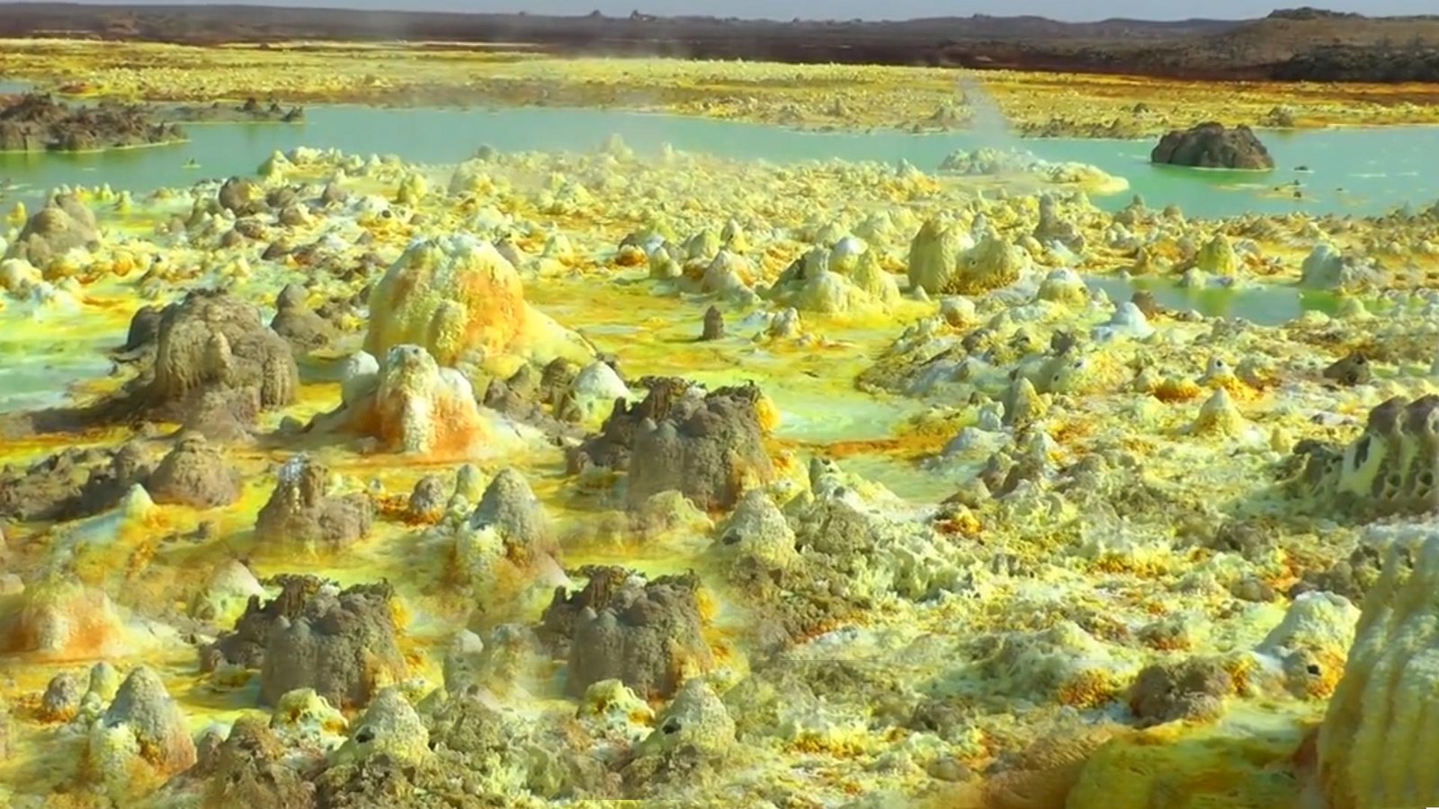 Yellow sulfur formations and green mineral pools